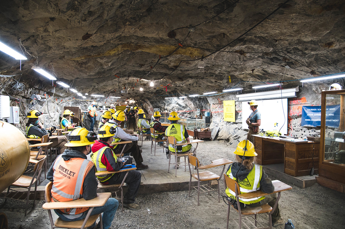 Students in a mine sitting in desks - mining classroom